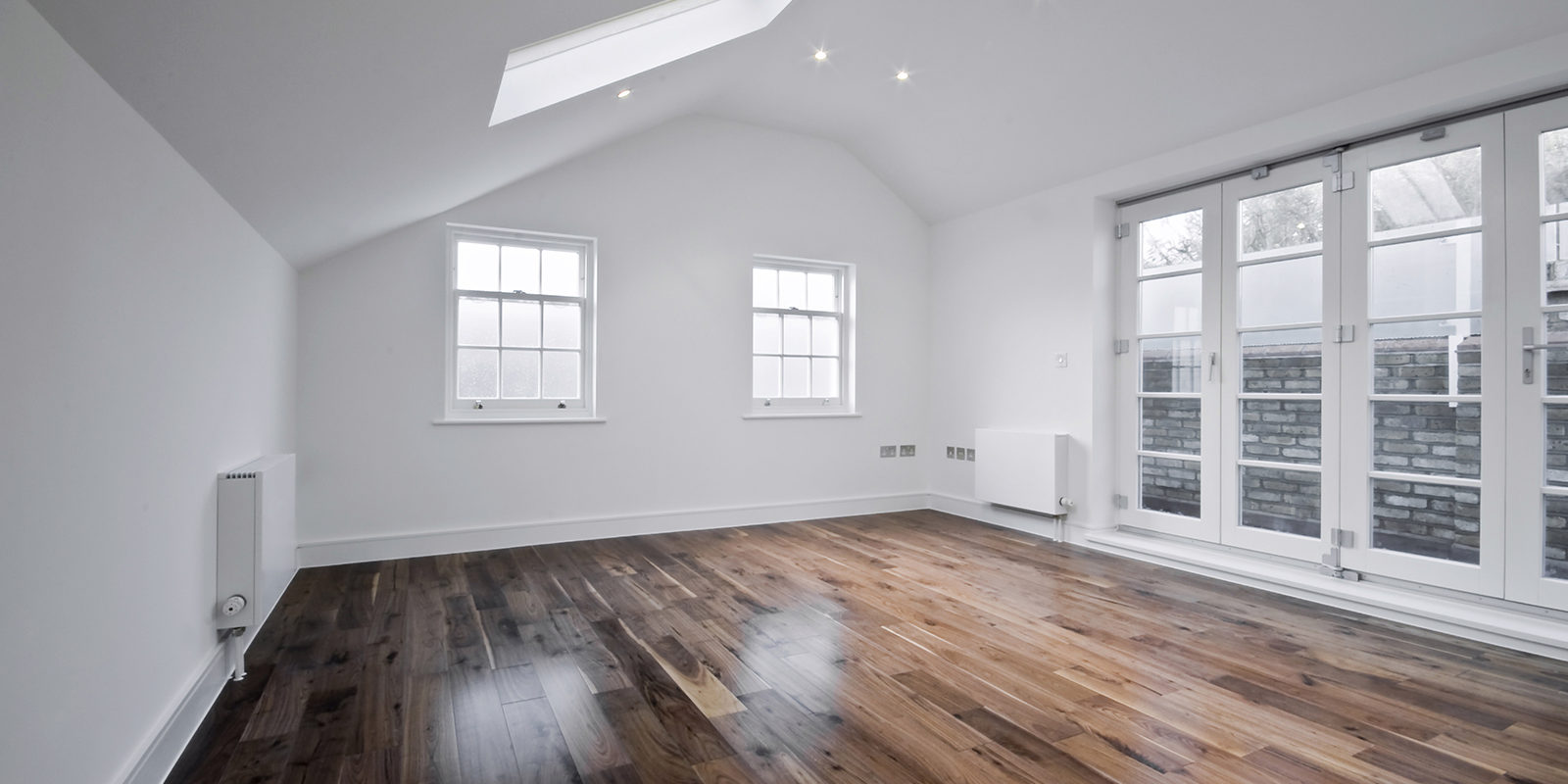 empty unfurnished loft room with roof window and solid wood floor empty unfurnished loft room with roof window and solid wood floor